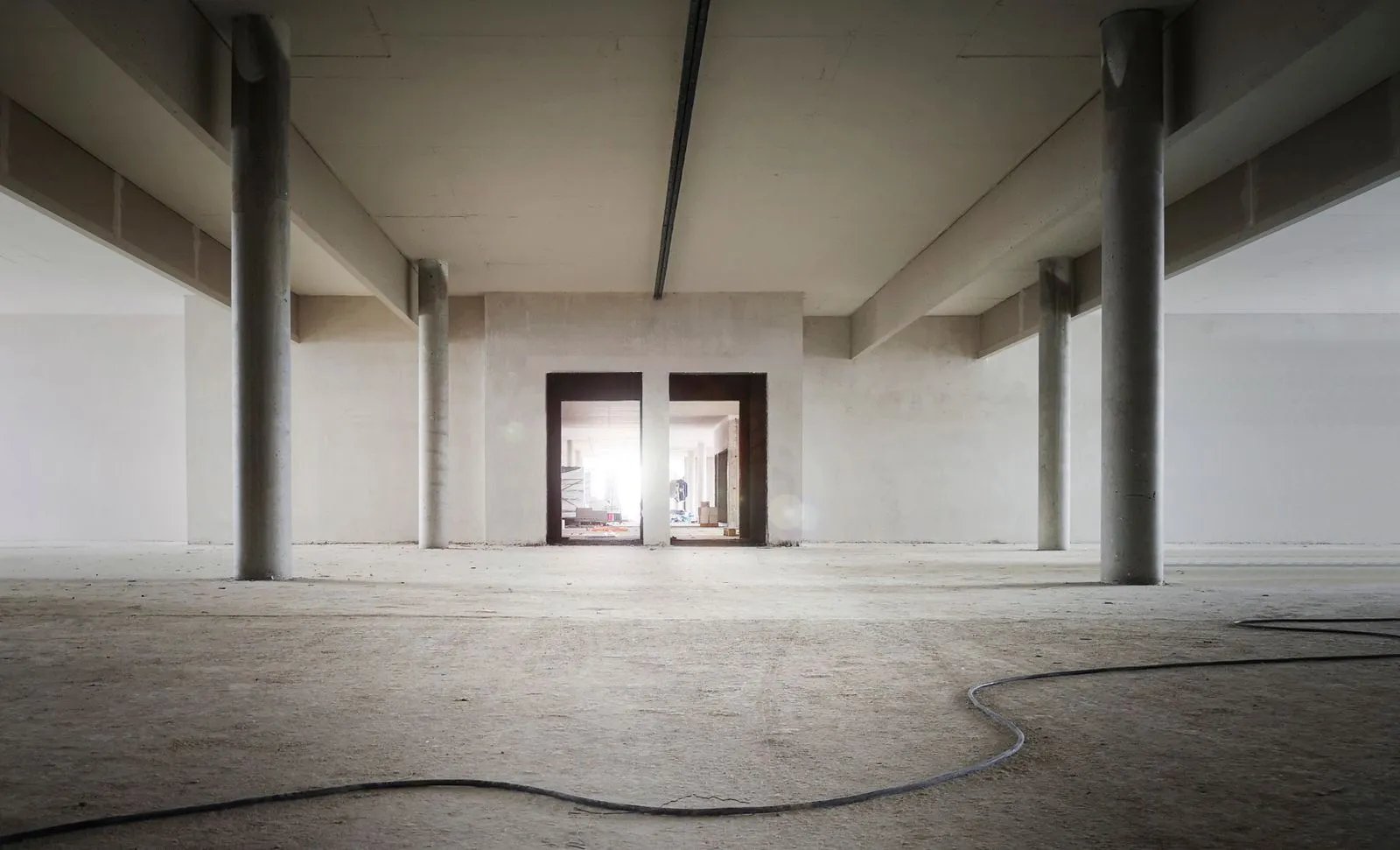 Unfinished basement with a concrete floor and block walls